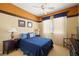 Cozy bedroom with a queen-sized bed, ceiling fan, and a sunny window with blue accents at 5747 Jaborandi Ave, Pahrump, NV 89061