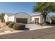 A beautiful home boasting a two-car garage, desert landscaping, and mature shade trees at 5747 Jaborandi Ave, Pahrump, NV 89061