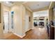 Bright hallway leading into the living room with hardwood floors and neutral paint at 5747 Jaborandi Ave, Pahrump, NV 89061
