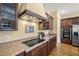Stylish kitchen featuring granite countertops, stainless appliances, and a cooktop at 5747 Jaborandi Ave, Pahrump, NV 89061