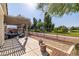Covered patio with seating, BBQ, and scenic view of the golf course and surrounding lush greenery at 5747 Jaborandi Ave, Pahrump, NV 89061