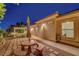 Charming backyard featuring a picnic table, a pergola, and well-maintained landscaping for a serene outdoor retreat at 6230 Calm Brook Ct, Las Vegas, NV 89149