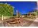 Inviting backyard with a picnic table and pergola, creating a relaxing outdoor space for dining and entertainment at 6230 Calm Brook Ct, Las Vegas, NV 89149