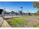 Community basketball court with chainlink fencing and lighting in a common area at 6230 Calm Brook Ct, Las Vegas, NV 89149