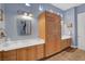 Well-lit bathroom features double sinks, ample cabinet space, and tiled floor at 6230 Calm Brook Ct, Las Vegas, NV 89149