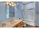 Well-lit bathroom with a marble countertop vanity and a glass-enclosed shower at 6230 Calm Brook Ct, Las Vegas, NV 89149