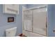Clean bathroom features a toilet, bathtub, shower, and updated fixtures at 6230 Calm Brook Ct, Las Vegas, NV 89149