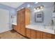 Well-lit bathroom features double sinks, ample cabinet space, and tiled floor at 6230 Calm Brook Ct, Las Vegas, NV 89149