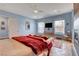 Spacious bedroom with a fireplace, seating area, and natural lighting at 6230 Calm Brook Ct, Las Vegas, NV 89149