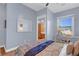 Bright bedroom with big window, desk, and ceiling fan features tiled flooring at 6230 Calm Brook Ct, Las Vegas, NV 89149