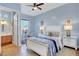 Stylish bedroom with ceiling fan, desk and ensuite bathroom, and decorative lamps at 6230 Calm Brook Ct, Las Vegas, NV 89149