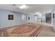 Expansive bonus room with a large rug, neutral carpet, and staircase access to other levels at 6230 Calm Brook Ct, Las Vegas, NV 89149