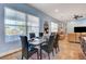 Elegant dining area with large windows and view of outdoor patio at 6230 Calm Brook Ct, Las Vegas, NV 89149