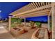Cozy outdoor entertaining area with fire pits and a covered patio, perfect for evening gatherings at 6230 Calm Brook Ct, Las Vegas, NV 89149