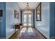 Elegant foyer with a chandelier, patterned tile floor, and a bench beneath decorative art at 6230 Calm Brook Ct, Las Vegas, NV 89149