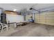 Well-organized garage featuring storage cabinets, overhead racks, and ample space for vehicles and projects at 6230 Calm Brook Ct, Las Vegas, NV 89149