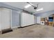 Clean and organized garage with built-in storage cabinets, washer and dryer, and exterior access at 6230 Calm Brook Ct, Las Vegas, NV 89149
