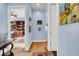 Hallway view looking toward built-in shelving, with neutral walls and decorative art at 6230 Calm Brook Ct, Las Vegas, NV 89149