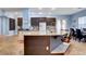 Open kitchen features a center island with seating and stainless steel appliances at 6230 Calm Brook Ct, Las Vegas, NV 89149