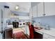 Well-lit laundry room with ample cabinet space, a sewing station, and modern appliances at 6230 Calm Brook Ct, Las Vegas, NV 89149