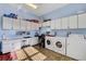 Bright laundry room with a long countertop, lots of storage, and side-by-side washer and dryer at 6230 Calm Brook Ct, Las Vegas, NV 89149