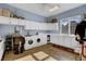 A functional laundry room with updated appliances, storage cabinets, and a stylist station at 6230 Calm Brook Ct, Las Vegas, NV 89149