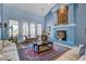 Spacious living room with fireplace and a large window to an outdoor patio area at 6230 Calm Brook Ct, Las Vegas, NV 89149