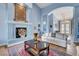 Elegant living room with fireplace and doorway to the home's foyer area at 6230 Calm Brook Ct, Las Vegas, NV 89149