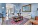 Elegant living room featuring stylish sofas, an ornate mirror, and a decorative area rug at 6230 Calm Brook Ct, Las Vegas, NV 89149