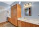 Well-lit bathroom with double sink vanity, storage cabinets, and decorative mirror at 6230 Calm Brook Ct, Las Vegas, NV 89149