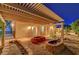 Inviting covered patio with brick fire pits, perfect for outdoor entertaining and enjoying cool evenings at 6230 Calm Brook Ct, Las Vegas, NV 89149