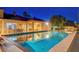 Captivating pool view highlighting backyard amenities, including dining area and a lush green landscape at 6230 Calm Brook Ct, Las Vegas, NV 89149