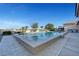 Inviting pool with lounge area, grill and verdant landscaping, perfect for summer relaxation and entertainment at 6230 Calm Brook Ct, Las Vegas, NV 89149