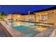 Stunning pool reflecting the lights of the home with a spa and outdoor dining at 6230 Calm Brook Ct, Las Vegas, NV 89149