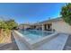 Beautiful backyard pool with lush landscaping, a spacious patio, and comfortable seating for outdoor enjoyment at 6230 Calm Brook Ct, Las Vegas, NV 89149