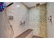 Modern walk-in shower with a built-in bench and stylish tile work at 6230 Calm Brook Ct, Las Vegas, NV 89149