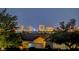 A scenic view of the Las Vegas skyline at night, as seen from behind a residential rooftop at 6230 Calm Brook Ct, Las Vegas, NV 89149