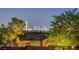 A scenic view of the Las Vegas skyline at night, as seen from behind a residential rooftop at 6230 Calm Brook Ct, Las Vegas, NV 89149