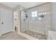 Bathroom featuring glass enclosed shower, white subway tile, and stone floor at 625 Honesty Ct, Henderson, NV 89011