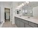 Elegant bathroom featuring double vanity sinks, modern lighting, and a separate walk-in shower at 625 Honesty Ct, Henderson, NV 89011