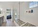 Bathroom showcasing a walk-in shower with mosaic tile flooring, modern fixtures, and a glass door at 625 Honesty Ct, Henderson, NV 89011