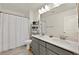 Bright bathroom featuring a double sink vanity with gray cabinets and a shower/tub combination at 625 Honesty Ct, Henderson, NV 89011
