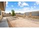Backyard featuring landscaping and a view of the house with a covered patio, plus a young, leafy tree at 654 Mazelle Ln, Pahrump, NV 89060