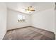 Bedroom featuring a ceiling fan, carpeted floors, and natural light at 654 Mazelle Ln, Pahrump, NV 89060