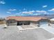 Well-maintained home with a two-car garage, low maintenance rock landscaping, and clean front facade at 654 Mazelle Ln, Pahrump, NV 89060