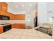 Bright kitchen features stainless steel appliances, wood cabinets, and tile countertops at 654 Mazelle Ln, Pahrump, NV 89060