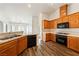 Well-lit kitchen features stainless steel appliances, wood cabinets, and vinyl floors at 654 Mazelle Ln, Pahrump, NV 89060
