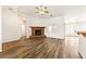 Living room with wood floors, fireplace, and open layout leading to other rooms in the house at 654 Mazelle Ln, Pahrump, NV 89060