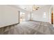Spacious living room with a ceiling fan and sliding glass doors to the backyard at 654 Mazelle Ln, Pahrump, NV 89060