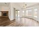 Bright open floorplan with a fireplace, dining area, and a sliding glass door to the backyard at 654 Mazelle Ln, Pahrump, NV 89060